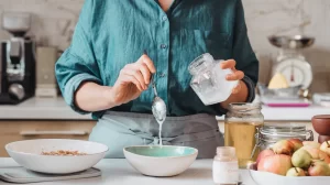 women adding coconut wooden press oil in food